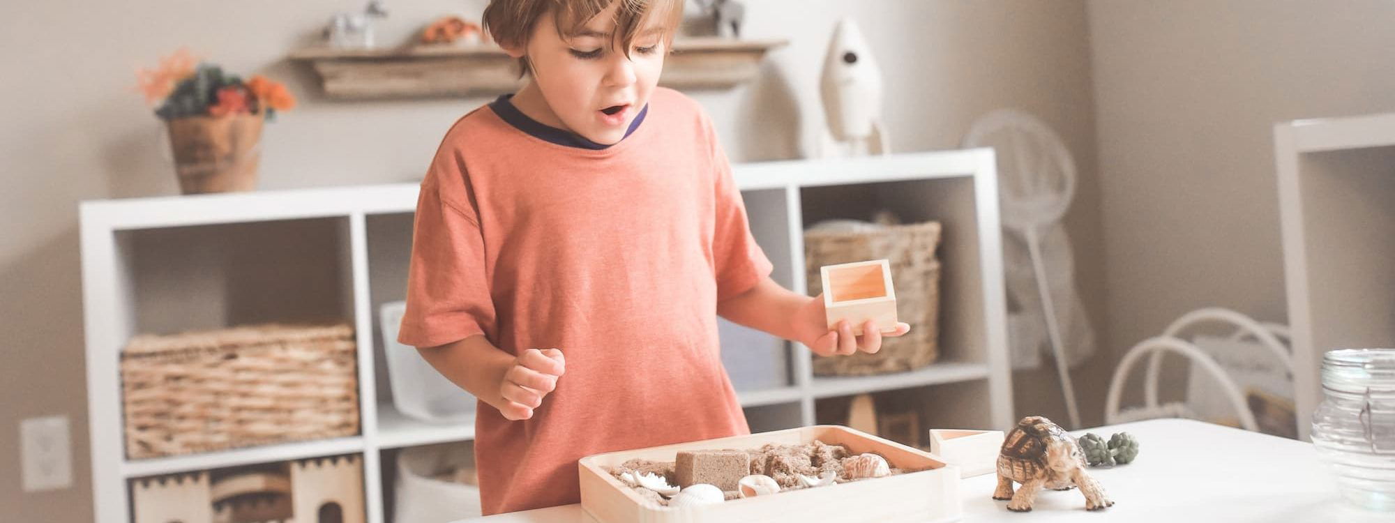 Boy playing with toys in sand