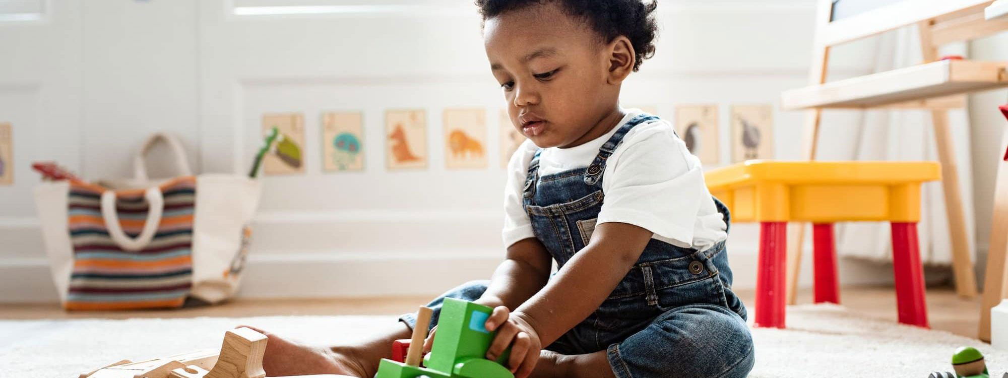 Child playing with wooden toys