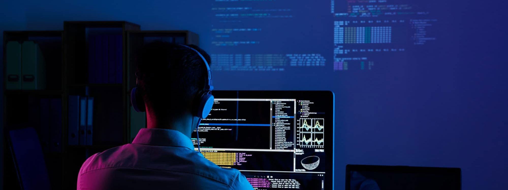 Person working on code in dark light