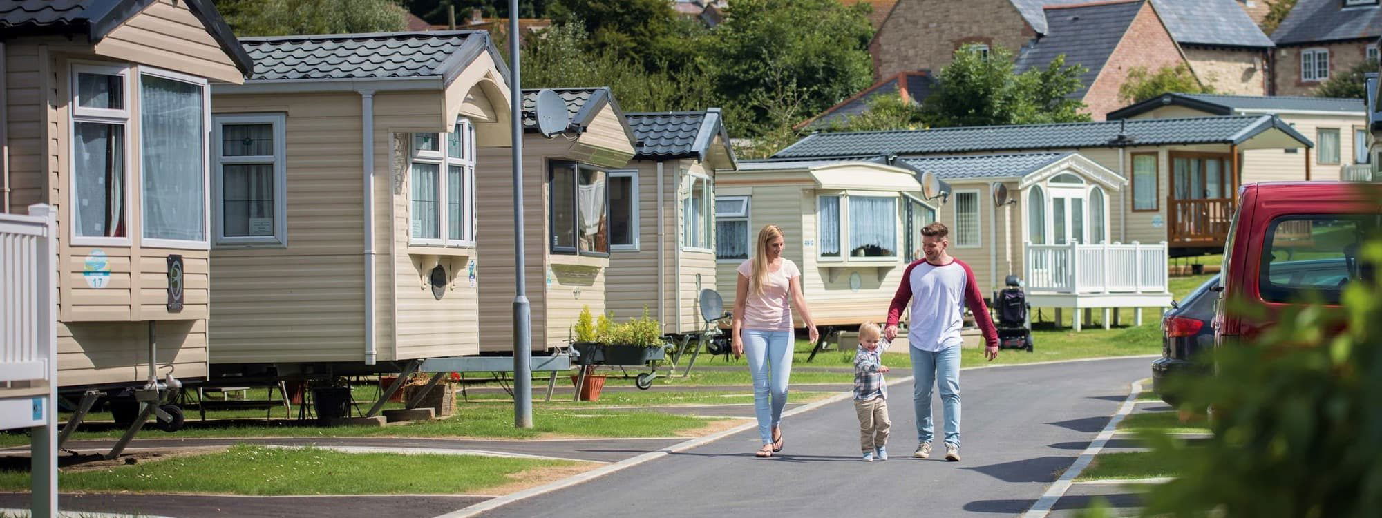 Family walking at static caravan holiday park